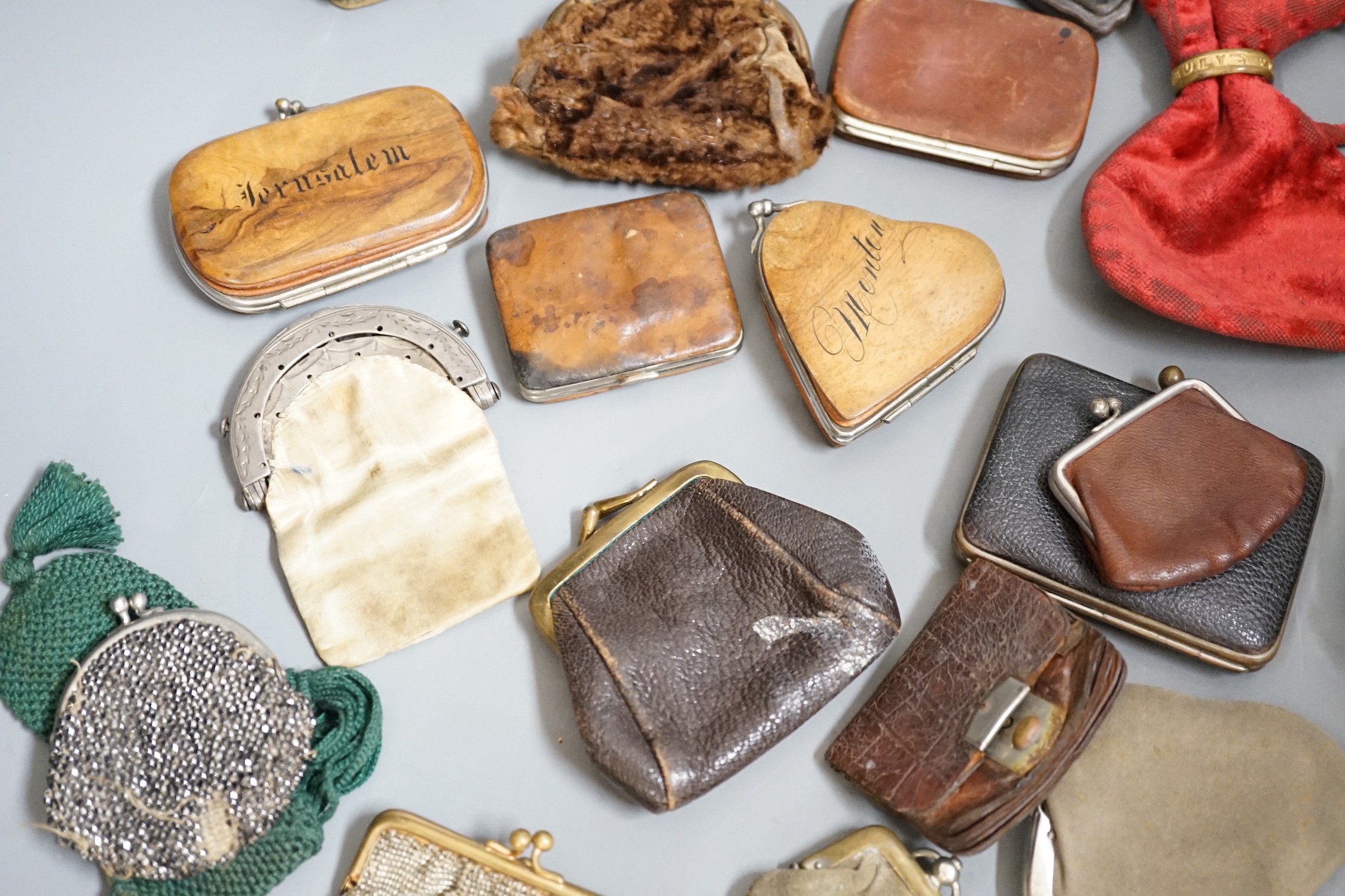 A collection of mostly Grand Tour, wooden souvenir purses and other 19th and 20th century leather and fur purses